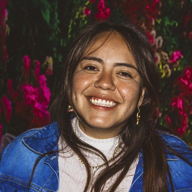 Kaveri Mehta, Lead Design Curator at Mellow Path Planet, reviewing corporate floral arrangements